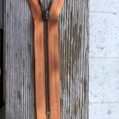 Orange satin ribbon metal zip with non-lock slider.